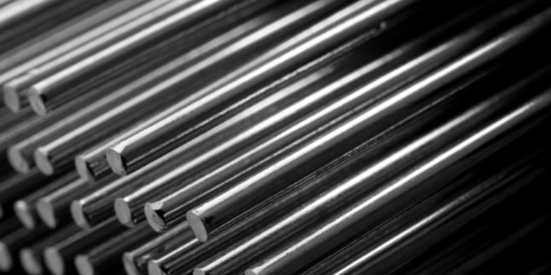 Rows of Steel Round Bar storage and stacking in the warehouse for industrial construction.